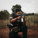 a man holding a rifle