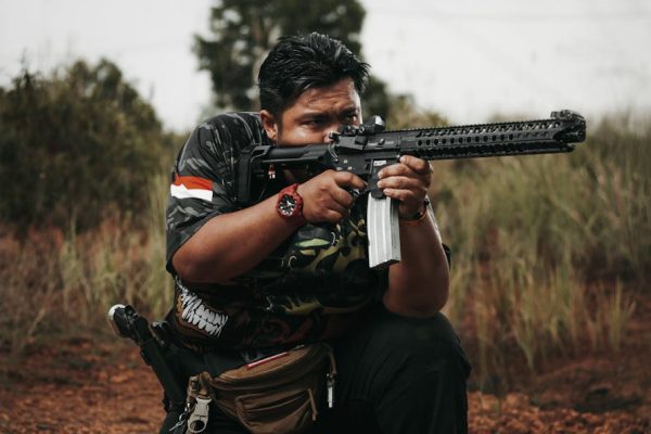 a man holding a rifle